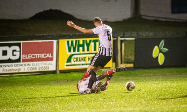 Fraserburgh's Kieran Simpson, standing, tangles with Brechin's Botti Biabi which resulted in the visitors being awarded a penalty. Images: Wullie Marr