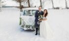 Chris and Georgie George, from Macduff, posing with Archie the campervan on their wedding day. Image: Megan Jack Photography.