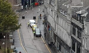 Police speaking to drivers they pulled over on Schoolhill, as part of efforts to enforce pedestrian and cyclist only rules in the area. Image: Kieran Beattie/DC Thomson.