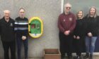 Members of the PTA and St John Scotland with the newly installed defibrillator at Crombie Primary School. Image: Aberdeenshire Council.