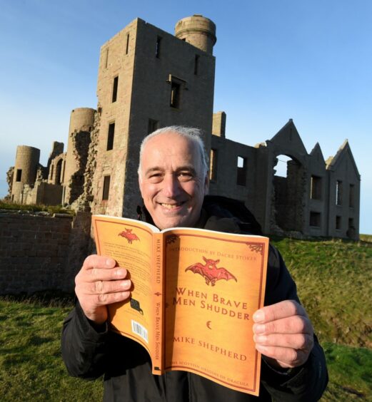Mike Shepherd with an earlier book about Bram Stoker's visits to Cruden Bay.  Slains Castle is in the background