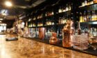 Classic bar counter with bottles in blurred background