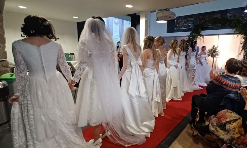 A line up of all the UHI West Highland beauty students in their bridal gowns