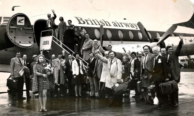 Being piped aboard their plane at Aberdeen by Carol Sim are the north-east business people taking part in the 1974 trip to OTC in Houston, Texas. Image: Aberdeen Journals Ltd.