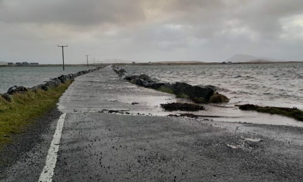 The Baleshare causeway. A large portion of it is covered in water,