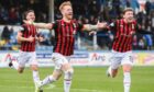 David Carson, centre, leads the Inverness celebrations after netting the winner at Morton. Images: Sammy Turner/SNS Group