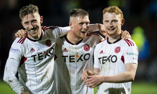 Aberdeen's Angus MacDonald, Mattie Pollock and Liam Scales (L-R) after the 1-0 win at Ross County. Image: SNS