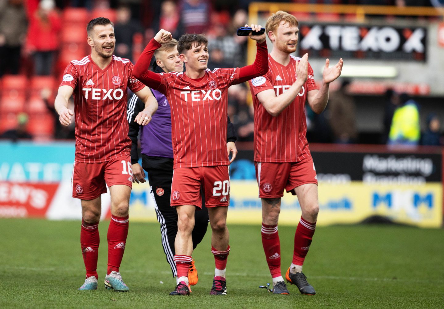 Leighton Clarkson and other Dons players celebrating after a game