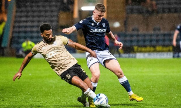 Cove's Shay Logan battles with Dundee's Luke McGowan at Dens Park. Image: SNS.