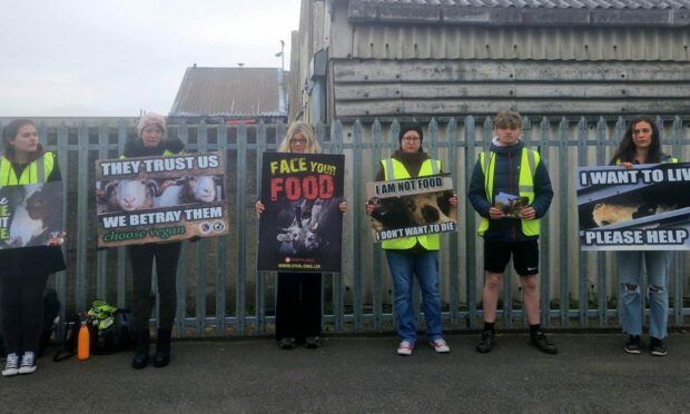 The vegan protestors in Inverurie have rejected claims they were "intimidating" protestors outside Strathburn primary school. Image: Rebecca Knowles.