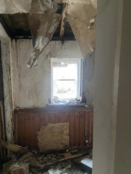 One of the rooms in Jimmy Savile house, with destroyed ceiling and debris on the floor.