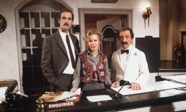 John Cleese, Connie Booth and Andrew Sachs in Fawlty Towers. Image: Shutterstock.