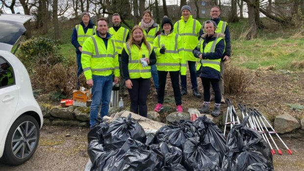 Volunteers help clean up the banks of the River Don. Image: AGS Airports.