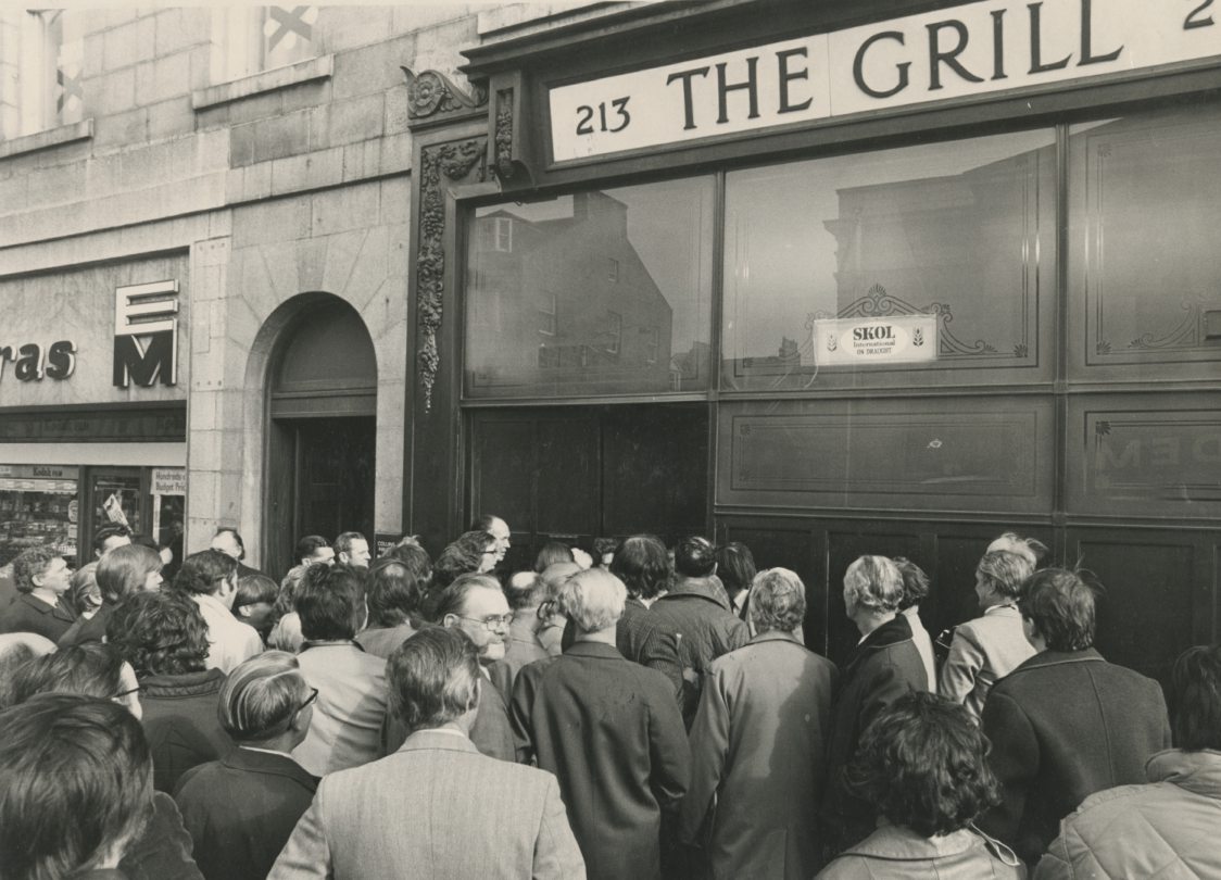 Men and women are gathered in front of the Grill Bar, Aberdeen, women trying to gain access for the first time.