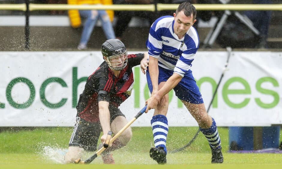 Oban's Daniel Sloss, left, challenges Michael Russell of Newtonmore on the pitch