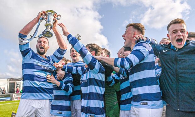 Banks o' Dee captain Kane Winton, left, lifts the Highland League Cup after Saturday's final. Image: Darrell Benns/DC Thomson