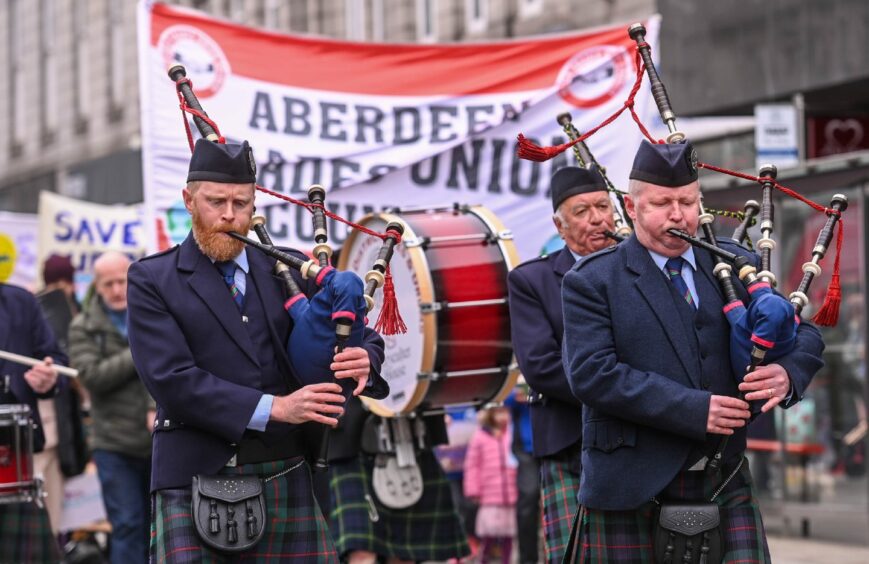 Pipers are pictured in front of an Aberdeen Trades Union Council banner during May Day march.