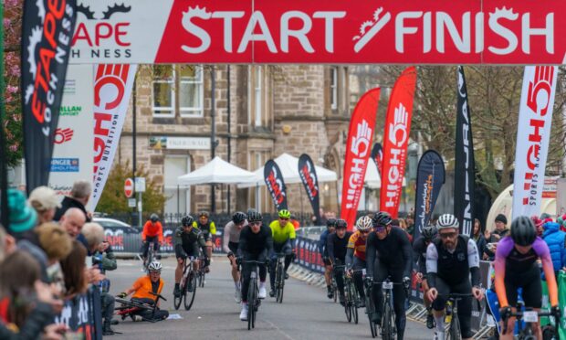 Cyclists headed for a busy Etape Loch Ness finish line.