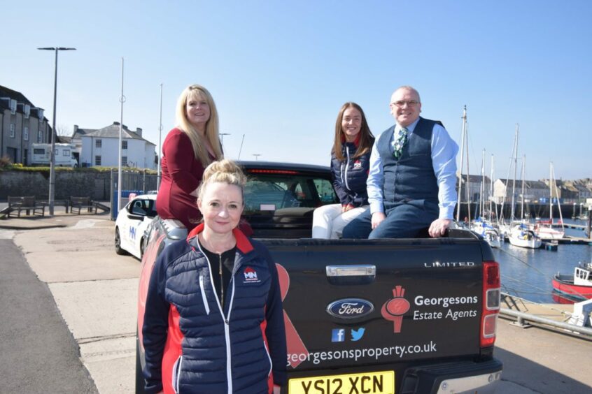 Munro and Noble and Georgesons Solicitors teams on a pick-up truck