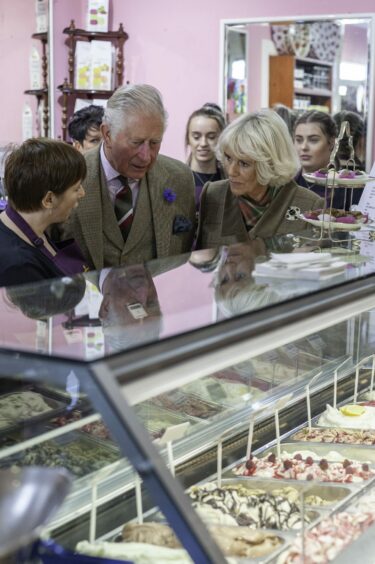 Owner Marjory Stephen chats with Charles and Camilla on their visit to the 120-year-old sweet shop.
