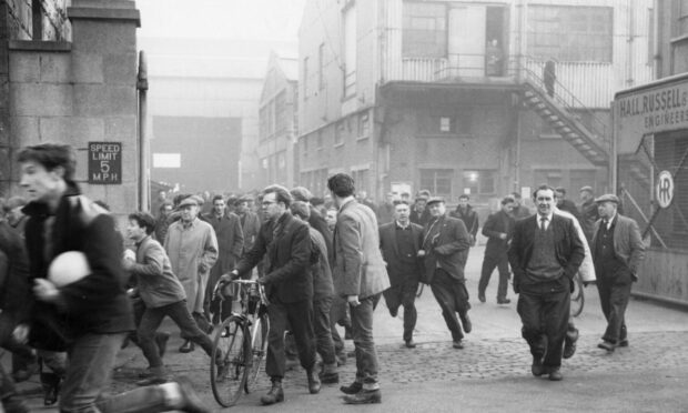 Workers' lunchtime rush at the Hall Russell shipyard, Footdee, Aberdeen, in 1963. Image: DC Thomson