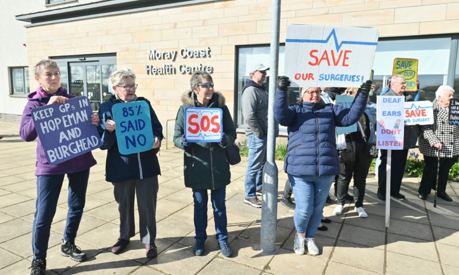 Campaigners with signs outside Moray Coast Health Centre. 