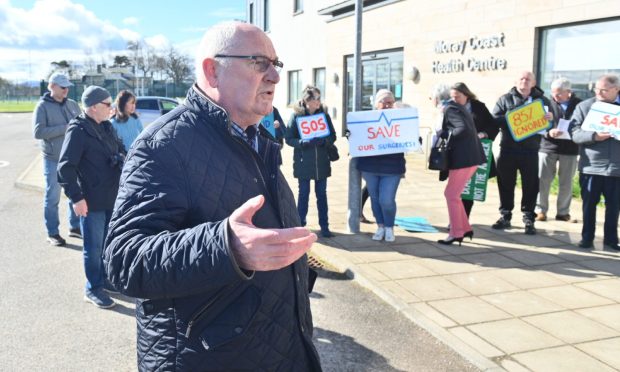 Dennis Slater addresses protest crowd outside Moray Coast Medical Practice.