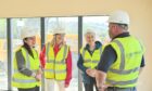 Kate Forbes (left) with  community fundraiser Rhona Matheson and Elsie Normington being shown around The Haven building by site manager Greg Cooper. Image Jason Hedges/DC Thomson