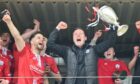 Brechin boss Andy Kirk celebrates with his players and the Breedon Highland League trophy at the end of last season
