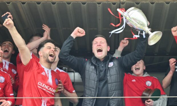 Brechin boss Andy Kirk celebrates with his players and the Breedon Highland League trophy at the end of last season