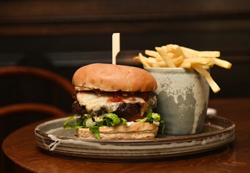 The Drouthy Cobbler's scotch beef burger with crispy bacon, cheddar, house relish and fries.