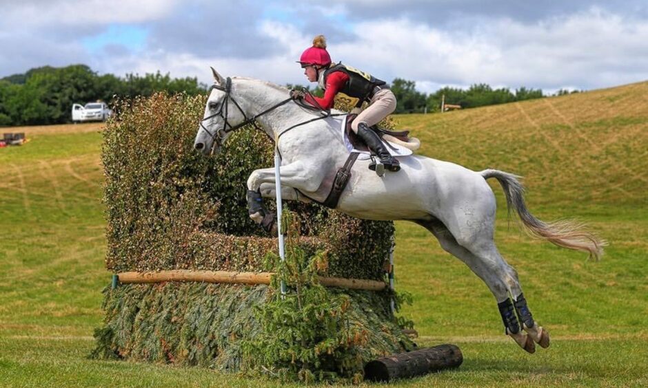 Jodie Sloss on horseback during a competition for British Eventing. 
