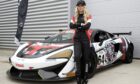 Jodie Sloss standing with her arms crossed in front of the McLaren 570FGT4.