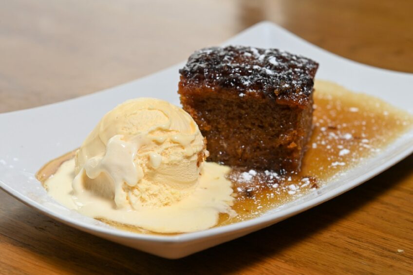 Sticky toffee pudding with a scoop of ice cream