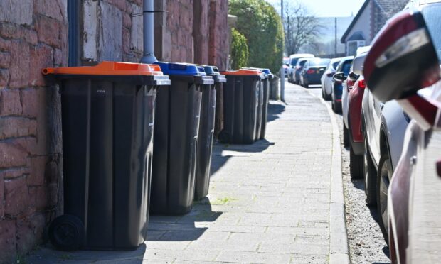 The new bins with orange lids are being rolled out across Aberdeenshire. Here's some of them already in place in Laurencekirk. Image: Kenny Elrick/DC Thomson