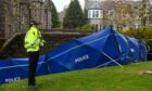 Police are standing near to a cordoned off at Belmont Gardens where a body was found. Image: Kenny Elrick/DC Thomson.