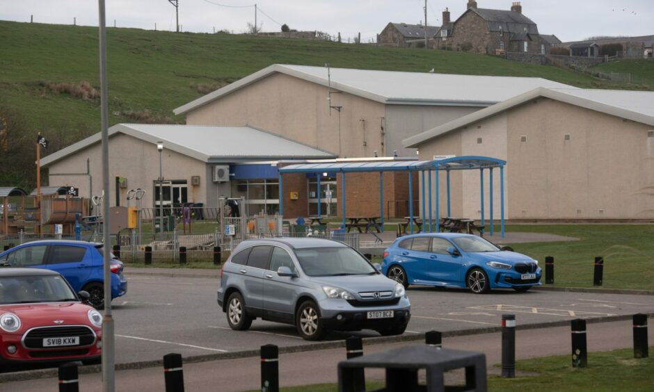 Outside of Stonehaven Leisure Centre, with cars parked.