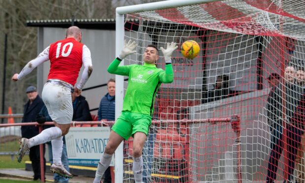 Ryan Smart scores for Culter past East End's goalkeeper Zack Ellis.     
 Image: Kami Thomson/DC Thomson