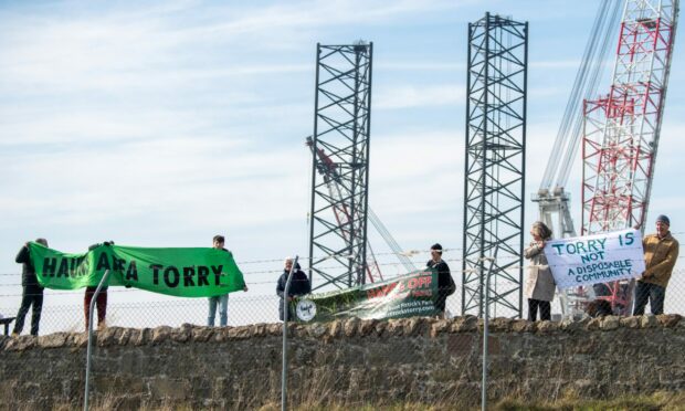 Protestors gathered with banners to share their views with the new first minister during his visit to Aberdeen on Tuesday. Image: Kami Thomson/DC Thomson.
