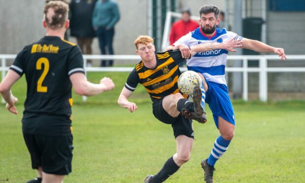 Dyce's Blair Johnston and Stonehaven's Joshua Christie battle for the ball. Image: Kami Thomson/DC Thomson