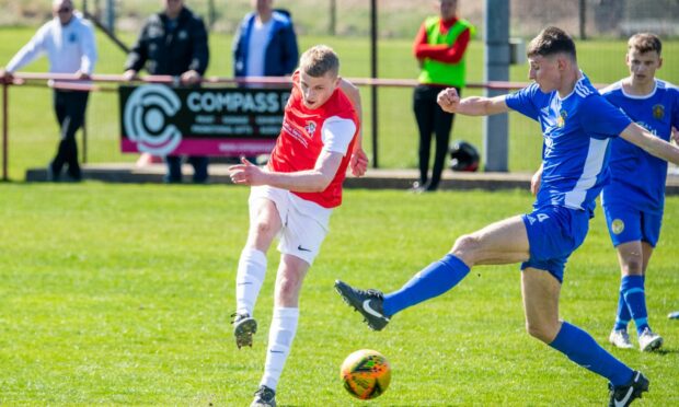 Culter's Cammy Fraser strikes, despite the attention of Stonehaven's Lee Taggart. Image: Kami Thomson/DC Thomson