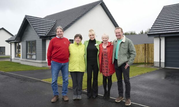 Jim Lachendro and Anne Sutherland, pictured left, have settled well into Woodside in Carrbridge. They are pictured with Jacqui O'Rourke, a sales consultant at Tulloch Homes and neighbours Richard and Caroline Bell. Photo supplied by The Big Partnership.