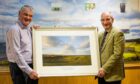 Royal Dornoch general manager Neil Hampton presents new honorary member Paul Lawrie with a framed print of the championship course. Image: Matthew Harris