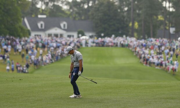 Rory McIlroy reacts to his shot on the first hole during the second round of The Masters. Image: AP.