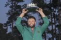 Jon Rahm holds up the trophy after winning the Masters on Sunday. Image: PA