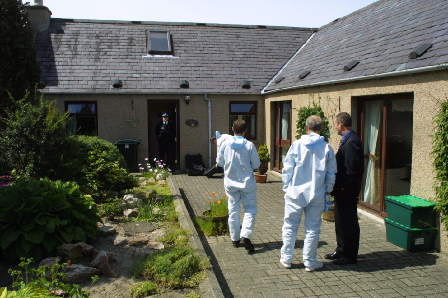 Forensics inspect the Elgin home of Arlene and Nat Fraser