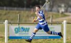 Newtonmore's Michael Russell scores against Kingussie in 2019. Image: Neil Paterson