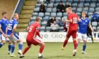 Peterhead's Jordon Brown with a header on target against Queen of the South. Image: Duncan Brown.