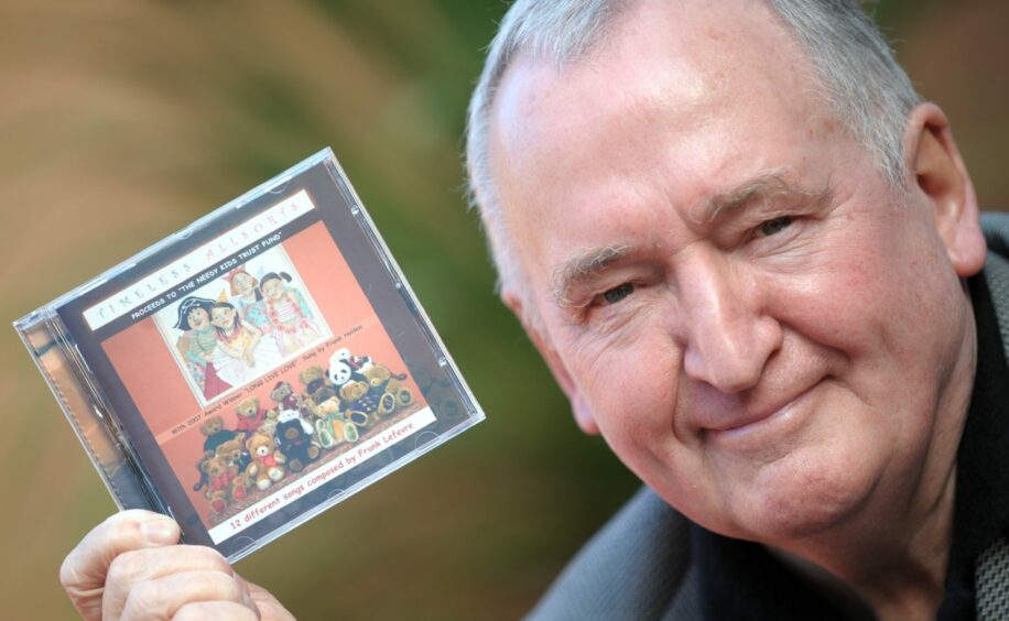 The Aberdeen solicitor holding the album he produced in 2008 to raise money for charity.
