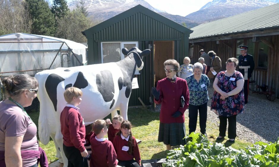 Banavie Primary School children demonstrate how to milk a cow for HRH Princess Anne
